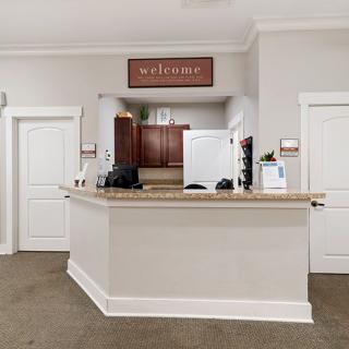 A modern kitchen interior with a central counter and welcoming decor.