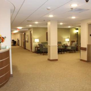 A view of a spacious hallway with a comfortable waiting area in an office setting.