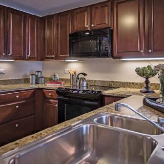 A modern kitchen with wooden cabinets and stainless steel appliances.