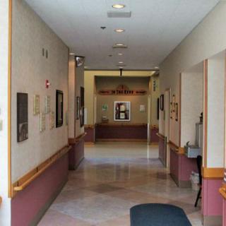 A view down an empty hallway leading to a reception area.