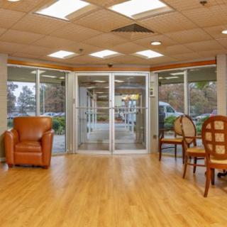 A spacious lobby area with comfortable seating and a glass entrance.