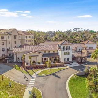 Aerial view of a residential complex with surrounding greenery.