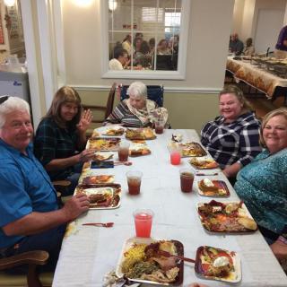 A family enjoying a meal together at a dinner table.