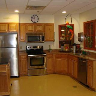 A modern kitchen with stainless steel appliances and wooden cabinets.