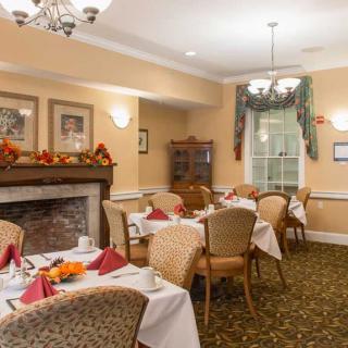 A cozy dining area with autumn-themed decorations and neatly arranged tables.
