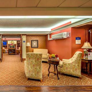 A cozy lobby area featuring comfortable seating and warm interior design.