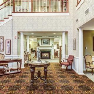 Elegant lobby area with seating and a fireplace.