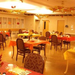 A warmly decorated dining area with tables and chairs set for guests.