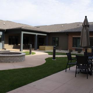 A modern backyard with a patio area and outdoor seating.