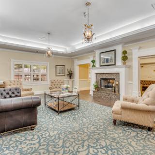 A beautifully designed living room featuring comfortable seating, a decorative fireplace, and an inviting ambiance.
