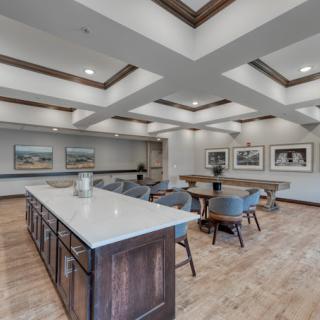 A modern conference room with a large table, comfortable chairs, and decorative artwork adorning the walls.