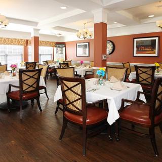 An elegant dining room with neatly arranged tables and chairs.
