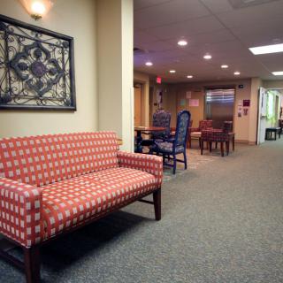 A cozy hallway with seating arrangements and soft lighting.