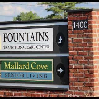 A sign for Fountains Transitional Care Center and Mallard Cove Senior Living at address 1400.