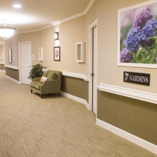 A well-lit hallway with comfortable seating and decorative elements.