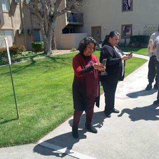 A group of people gathered outside, engaging in discussion.