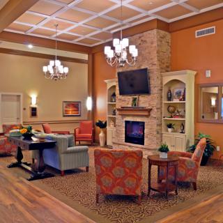 A cozy living room with a fireplace, television, and comfortable seating area.