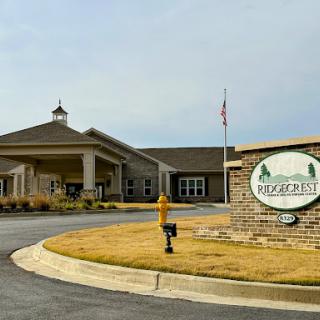 The entrance of a residential community featuring a welcoming sign.