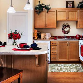 A cozy kitchen with wooden cabinets, a dining area, and decorative elements.