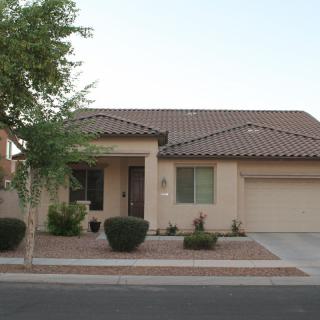 A suburban single-story house with a garage and driveway.