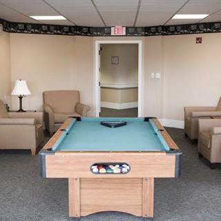 A cozy indoor recreational area featuring a pool table and comfortable seating.