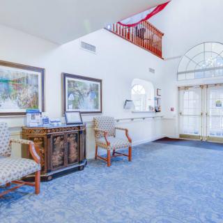 A spacious and bright lobby area with comfortable seating and decorative artwork.