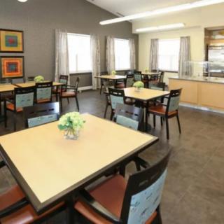 An indoor dining area with neatly arranged tables and chairs in a cafe or restaurant setting.