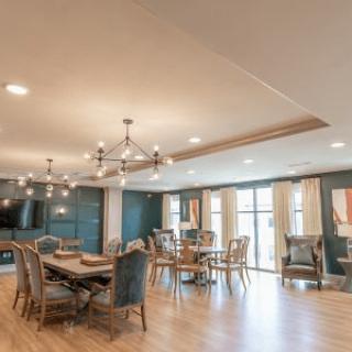 A spacious, modern dining room with elegant chandeliers and comfortable seating.
