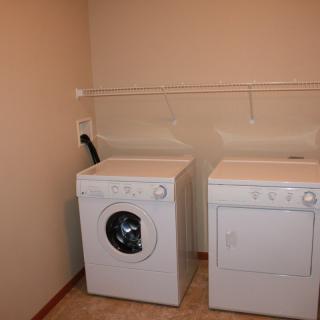A laundry room with a washing machine and dryer side by side.