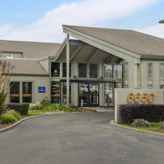 The entrance to a modern building with a welcoming design and clear signage.