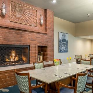 A cozy dining room with a fireplace and elegant seating arrangement.