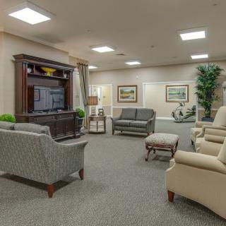 A spacious living room with comfortable seating, a large television, and tasteful decor.