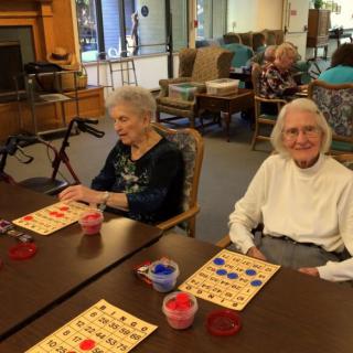 Elderly women enjoying a game of bingo at a community center.