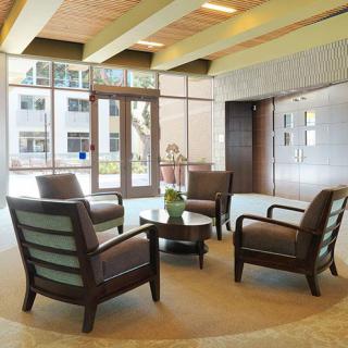 A modern lobby with comfortable seating arrangements and bright natural lighting.