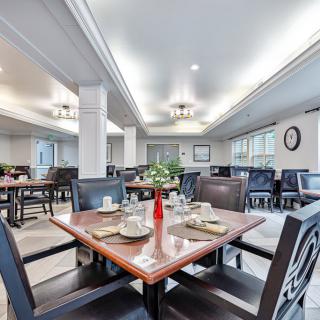 A well-lit dining area with neatly arranged tables and elegant decor.