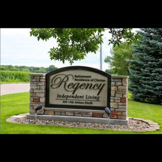 Welcome sign for the Regency Independent Living Community, surrounded by lush greenery.