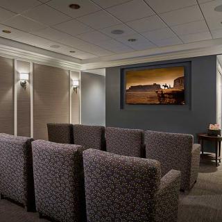 A modern home theater setup with comfortable seating and a large screen for entertainment.