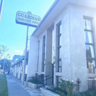 A street view of a building with a sign for Guardian Children's School.