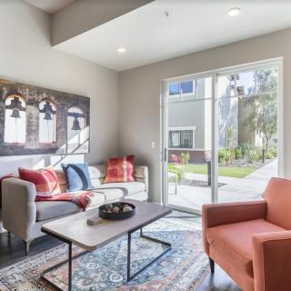 A modern living room with stylish furniture and ample natural light.