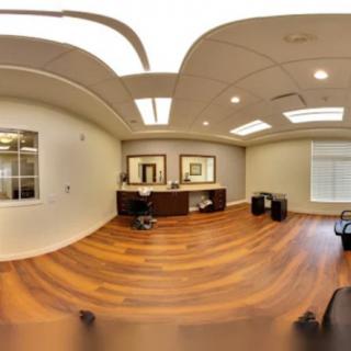 A modern office space with wooden flooring and contemporary furnishings.