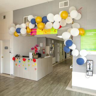 A decorated reception area with colorful balloons and festive decor.