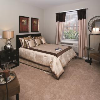 A cozy bedroom with elegant decor and a neatly made bed.