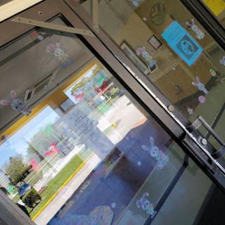A view of a storefront entrance with glass doors and visible signage.
