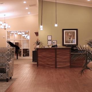 A cozy reception area with modern furniture and warm lighting.