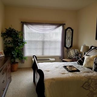 A cozy bedroom with classic furniture and natural light.