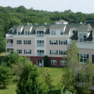 A residential apartment building surrounded by lush greenery.