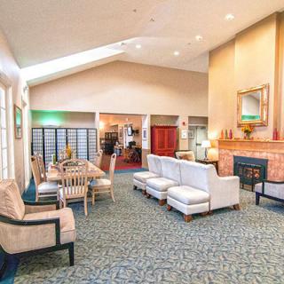 A spacious and elegantly designed hotel lobby with comfortable seating and a fireplace.