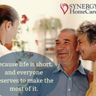 A caregiver shares a moment of joy with an elderly couple, emphasizing the importance of making the most of life.