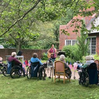 Residents enjoying a live music performance in the garden.