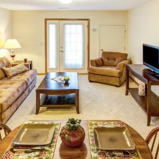 A cozy living room with comfortable seating and a television.